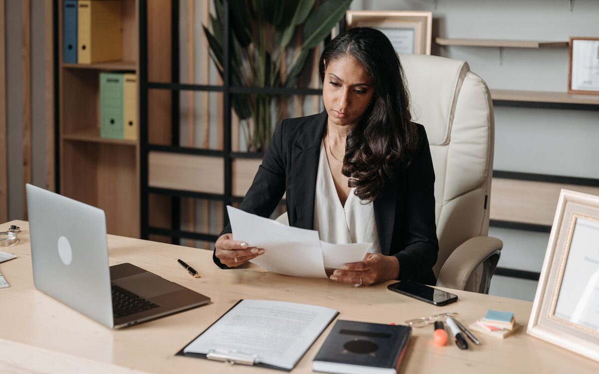 An accountant reviewing figures on a monitor