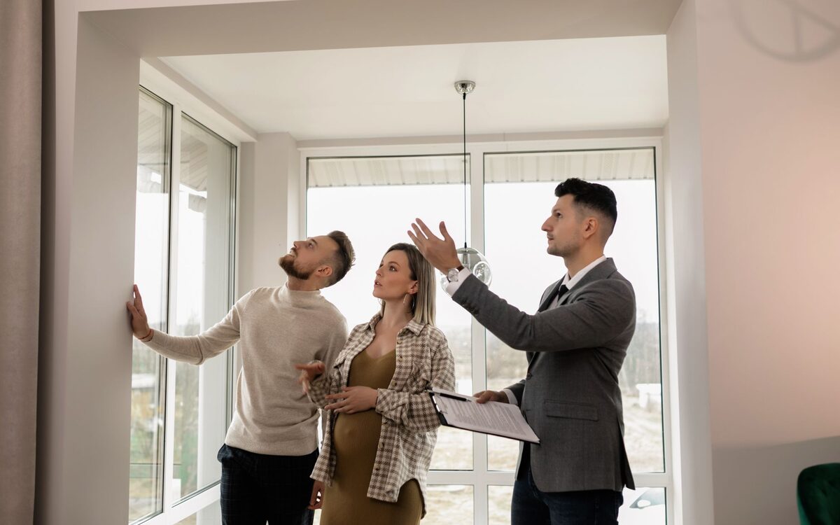 An estate agent showing a property to prospective buyers